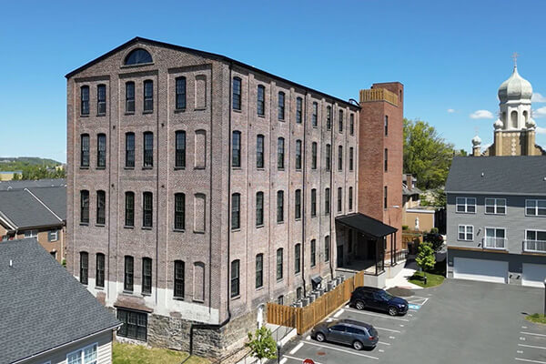 Historic multi-story brick building with parking.